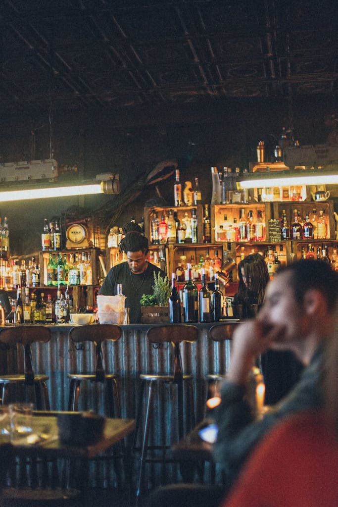 Atmospheric bar scene with diverse patrons enjoying drinks and lively ambiance.